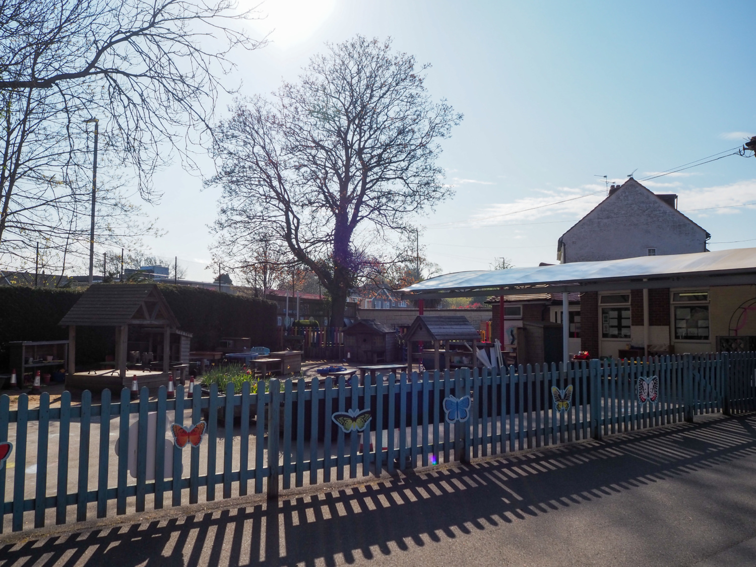 Exterior shot of the Oaks Primary Academy building, showing the outdoor play area.